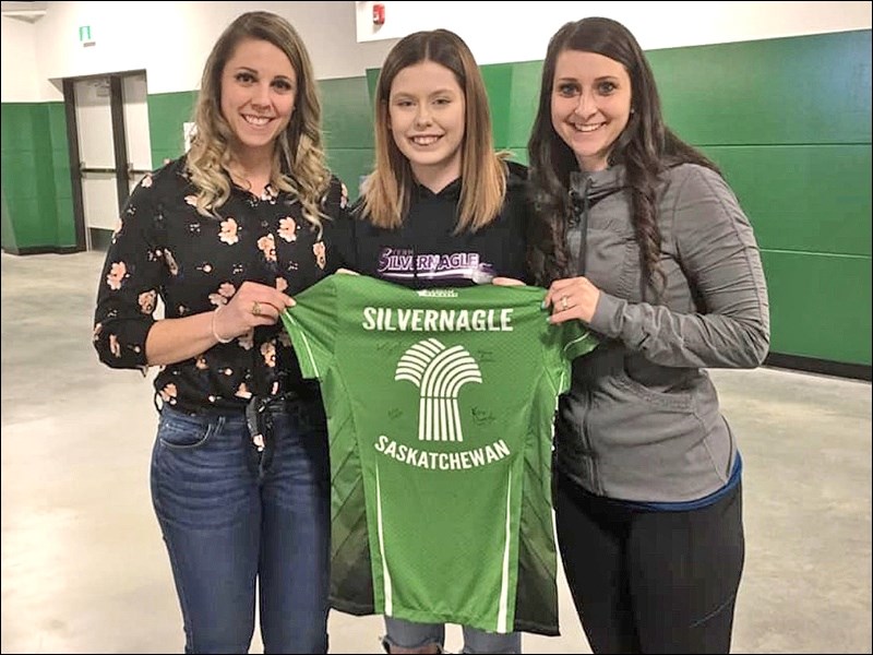SilverSquad fan Dakota Lipka (centre) seen with Robyn Silvernagle (left) and Kara Thevenot (right) receiving her Silvernagle Scotties jersey at Saskatoon. Photos submitted