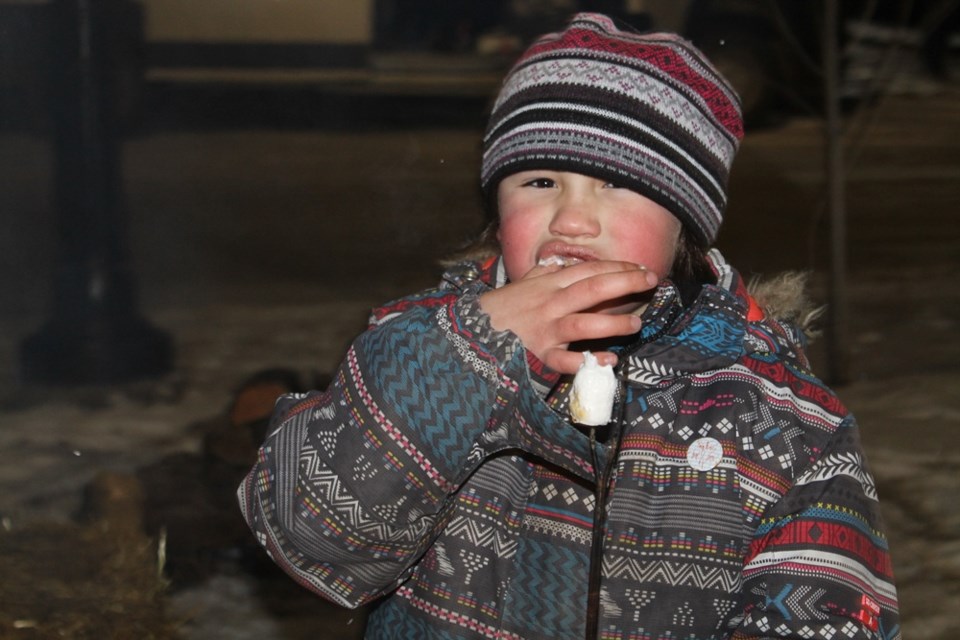 Jorja McFarlane eating a roasted marshmallow at the Nipawin Christmas tree lighting on Dec. 5. Photo by Jessica R. Durling