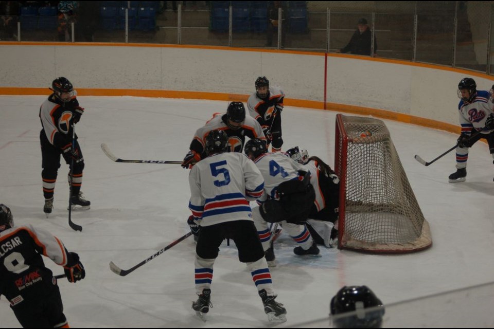 Jacob Danyluk, left, and Tony Olynyk of the Preeceville Pats midget team fought to shoot the puck to the net when Preeceville took on Yorkton in a home game that ended in a 6-1 win on December 3.