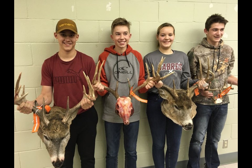 Four youth entries at the River Ridge Fish and Game horn measuring event on December 6, from left, were: Ethan Heshka, Everett Paley, Zoë Thomas and Mike Owchar Jr with his sister Emily’s trophy.