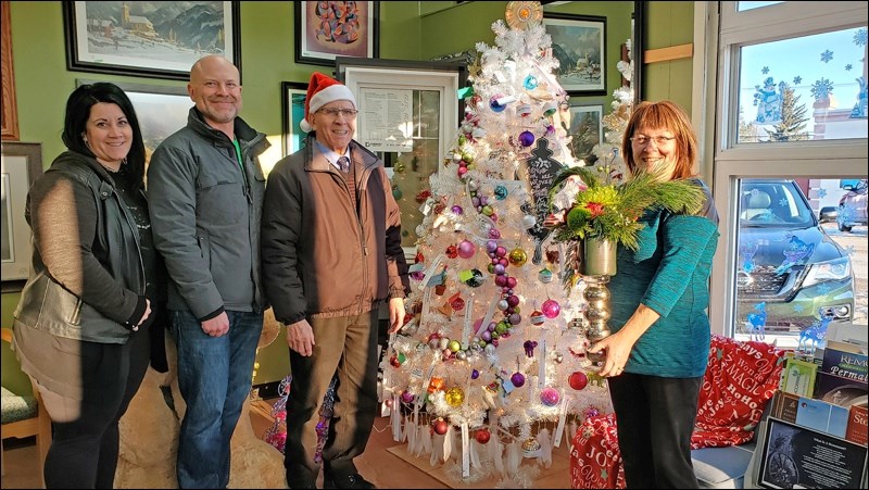 Image Glass was the winning Christmas tree in the decorating contest in the Dec. 5 Unity Winter Wonderland festivitie. Shown here receiving the prize is Shirley Reiter, presented by judges Nicole Headrick, Carey Baker and Mayor BenWeber.