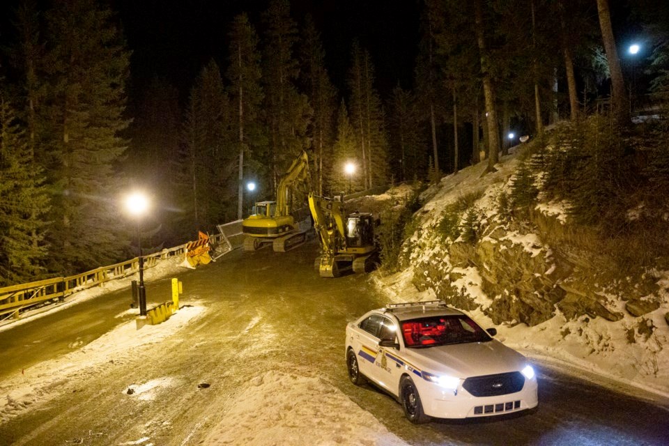 A Banff RCMP officer sits in a squad car patrolling the scene at the Fairmont Banff Spring Hotel whe