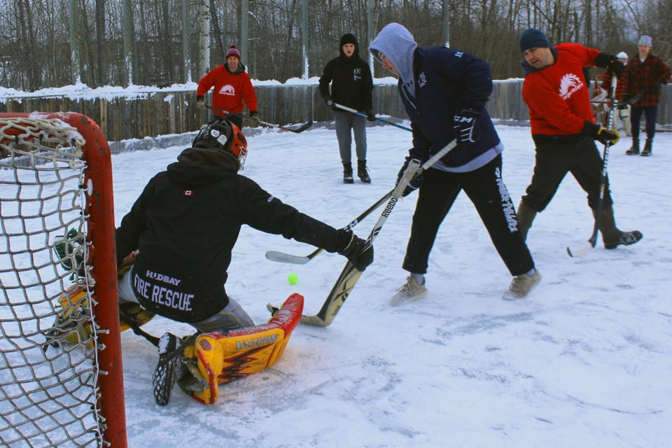 Ratt Construction goalie Derek Abrahamson spreads out to stop a shot by the Big Eddy Yetis’ Blake Lahonen. - PHOTO BY ERIC WESTHAVER