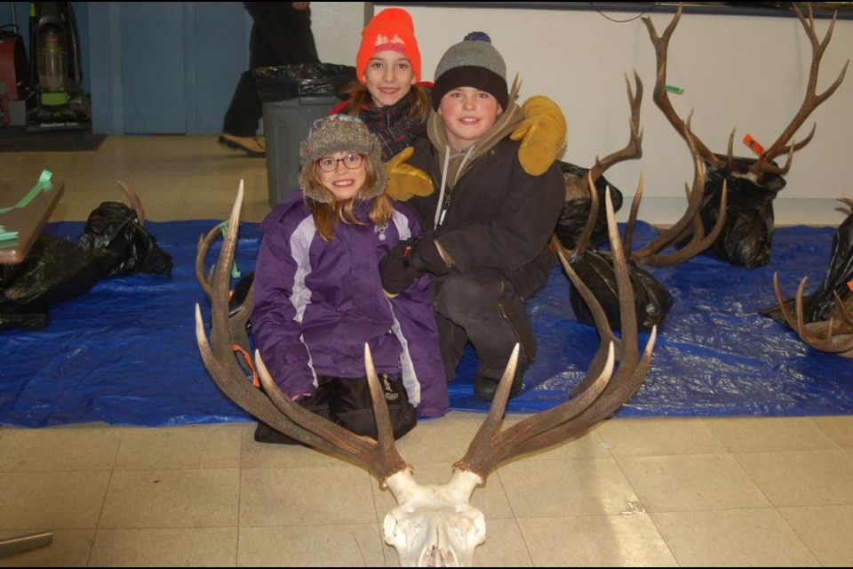 Youth in attendance who looked like they were enjoying the Sturgis Wildlife annual antler measuring at the Sturgis Kin Hut on December 13, from left, were: Savannah Neilson, Maggie Bartel and Alex Neilson.