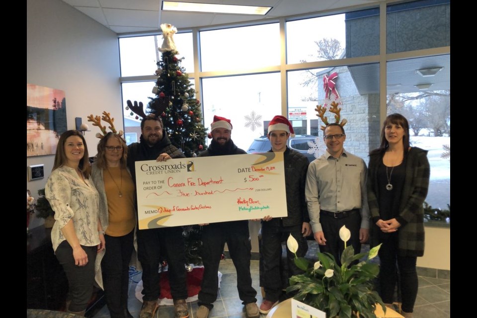 Crossroads Credit Union held its 12 Days of Crossroads Country Christmas from December 5 to December 20. During each of the 12 days, Crossroads staff either performed a “Random Act of Kindness” or a “Generous Giving” within communities served by Crossroads. On the day of the photo (the 11th Day) the Canora branch staff decided that its $500 surprise donation would be given to the Canora Fire Brigade. The $500 surprise donations made in other Crossroads communities were: The Sturgis READ Club in Sturgis, Preeceville Club 60 in Preeceville and The Royal Canadian Legion Branch in Wadena. From left, were: Sharon Ripa (Crossroads), Loralee Antonovitch (Crossroads), Devon Sawka (Canora Fire Dept.), Brendon Skibinsky (Canora Fire Dept.), Tyler Kopeck (Canora Fire Dept.), Jeff Bisschop (Crossroads) and Kristin Olson (Crossroads).