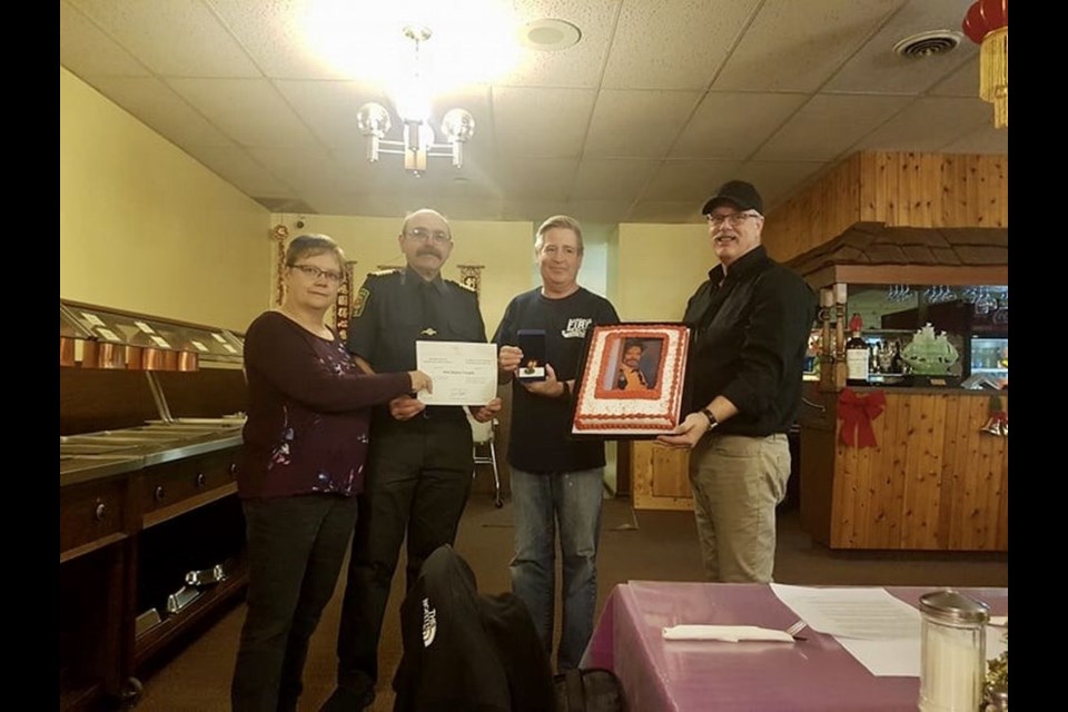 From left, were: Nancy Brunt, mayor; Ken Thompson, fire chief; Mark Forsythe, captain and Bruce Thomsen, deputy fire chief, during an award presentation.