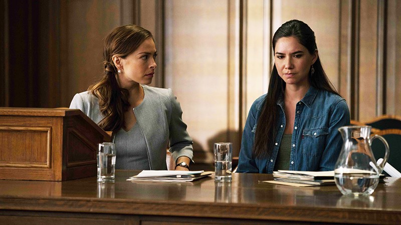(L to R) Joanna (Kristin Kreuk) with Kodie (Sera-Lys McArthur) at the custody hearing for her children during an episode of “Burden of Truth” which airs on CBC.