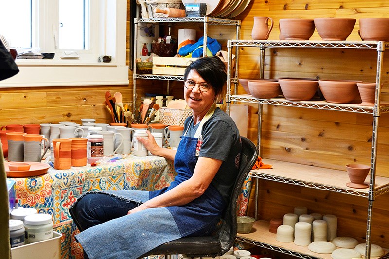 Amanda Myers, owner and operator of Lake Front Treasures, readies her pottery creations in her studio.