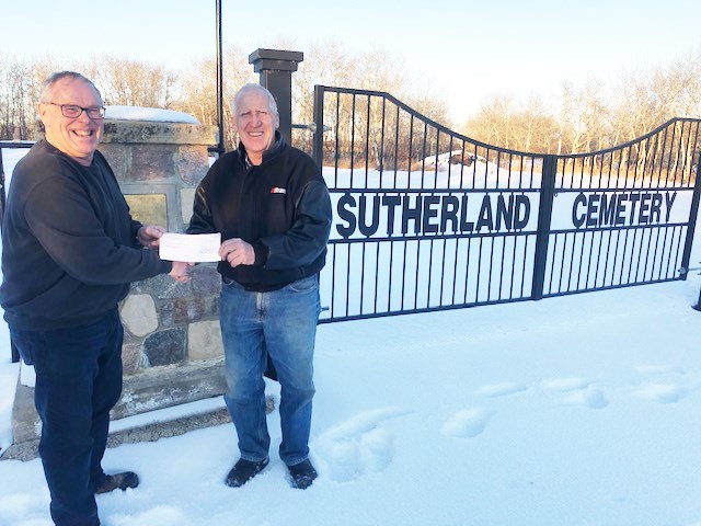 Jack Wilson (right), representing the Bear Claw Community Development Corp., presents a cheque to Wayne Wilson on behalf of the Sutherland Cemetery. The donation will go towards upgrades to the Cemetery.