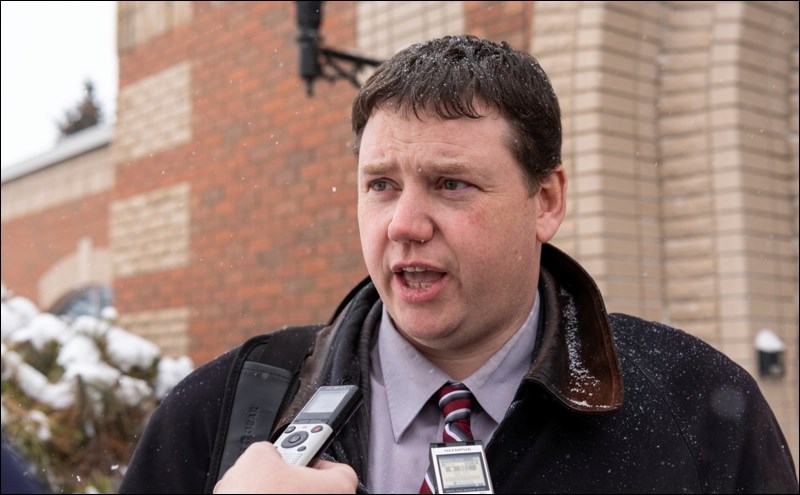 Prosecutor Chris Browne talks to reporters outside the courthouse.