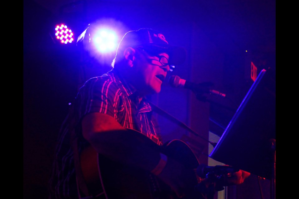 Ron Burwash took to Johnny’s Social Club stage for a solo set during the Blueberry Jam Musical Gathering. The Flin Flon musician played throughout the weekend, bringing his acoustic stylings to hundreds of people. - PHOTO BY CASSIDY DANKOCHIK