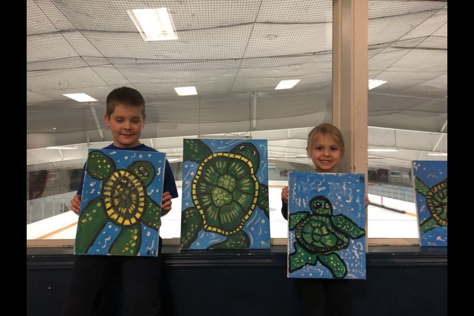 From left, Carson and Harper Chernoff displayed their completed Paint Night projects of ASKI Turtle.