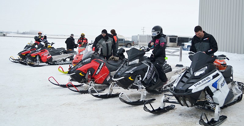Snowmobile enthusiasts get ready to set off for the day’s ride at the annual Arcola Optimist Club Snowmobile Rally.