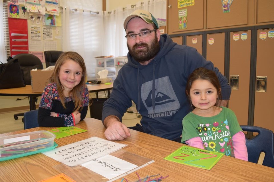 Olivia Owchar, left, welcomed her father Kevin and her younger sister Keira, 4, to Kindergarten Family Literacy Day on January 30, where they were making letters and other shapes out of Wikki Stix.