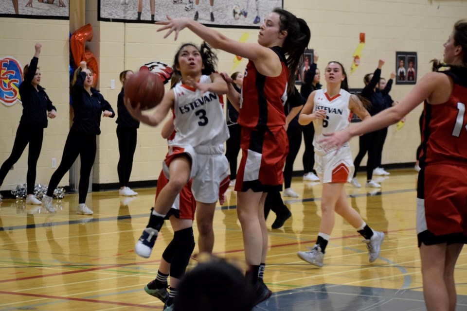 Bethany Montebon (3) of the Elecs looks for a way past a Weyburn defender during the senior girls basketball game.