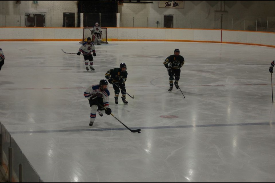 Shelby Wallin, (foreground) and Todd Pankratz (white jerseys) got the Preeceville midget Pats off to a quick start.