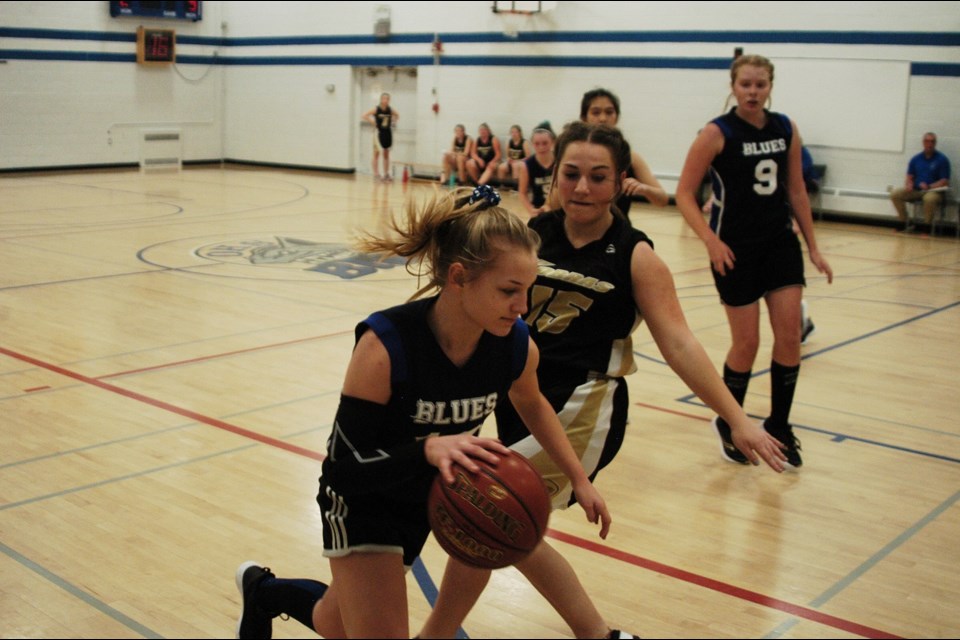 Outlook's Taebyn Tulp darts down court in the Blues' first game against Kindersley.