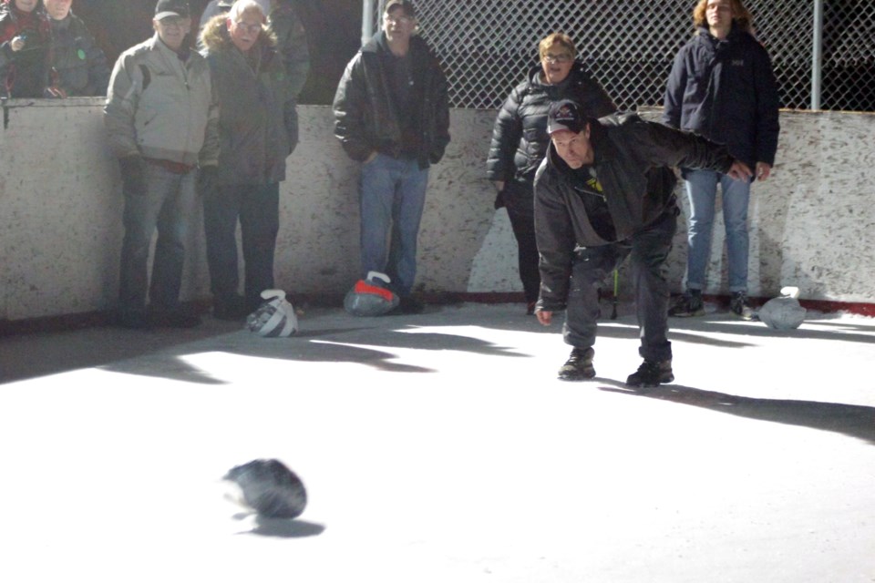 Denare Beach village councillor Scott McCullum throws a “stone” during the council challenge at the annual Turkey Curling World Championships. Councils from Flin Flon, Creighton and Denare Beach each took part in a special round robin sub-tournament. - PHOTO BY ERIC WESTHAVER