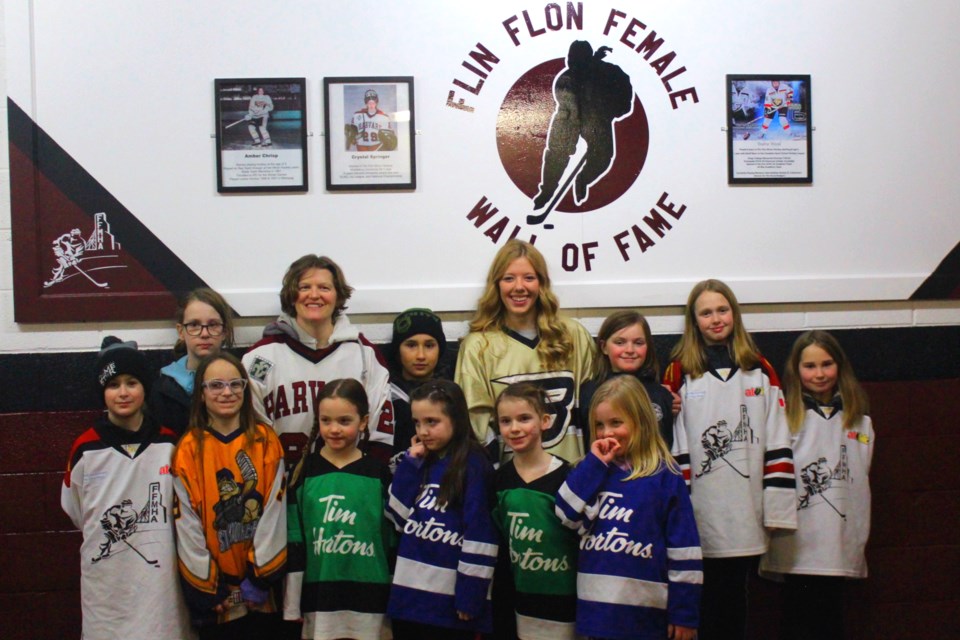 Springer and Wood pose with the next generation of Flin Flon female players.- Photo by Eric Westhaver