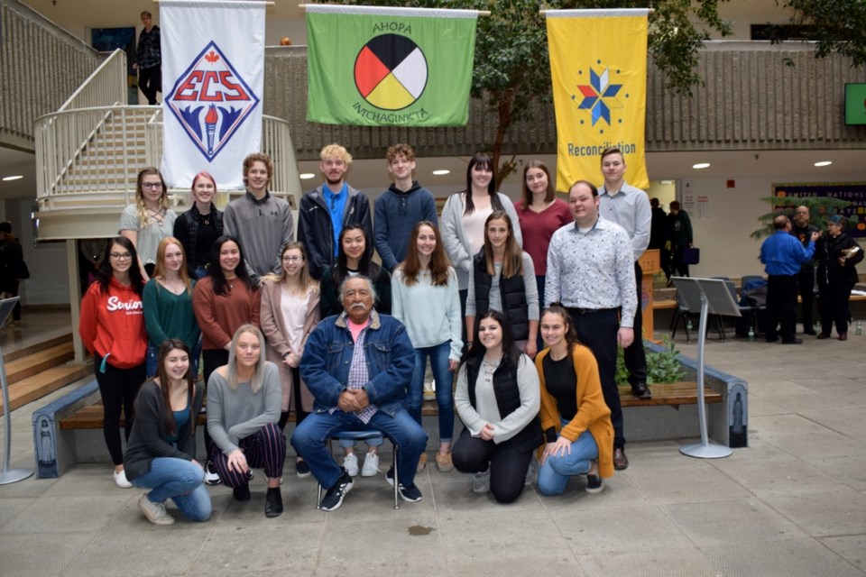 Members of the Estevan Comprehensive School’s leadership 30 class gather with elder Peter Bigstone following the unveilling ceremony for the school’s new Indigenous garden.