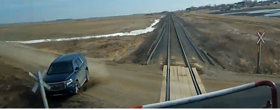 Blue SUV almost collided with a train and then hit the ditch and the railway crossing sign. Photo submitted