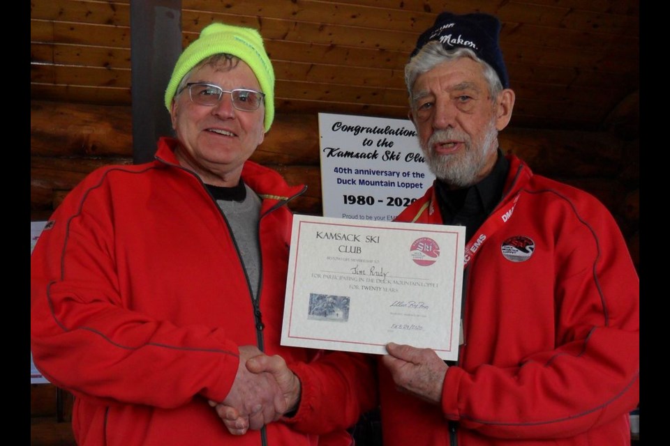 Jim Rudy, left, received his 20-year Lifetime Certificate from Bruno Lemire, loppet chair, on February 29 during the 40th annual Duck Mountain Loppet held at Duck Mountain Provincial Park.