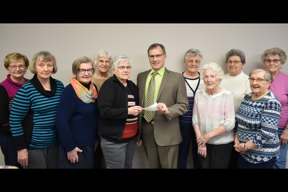 On March 6, Ross Fisher, executive director of the Health Foundation of East central Saskatchewan, accepted a cheque in the amount of $5,000 from the members of the Kamsack Hospital auxiliary. From left, were: (back) Stella Sych, Marj Orr, Pauline Bear, Marg Popoff and Betty Salahub, and (front) Margaret Ratushny, Colleen Bernard, Diana Belovanoff (auxiliary president), Fisher, Betty Fedorak, and Loreen Achtymichuk. Olga Rezansoff and Lena Machushek were unavailable for the photo.
