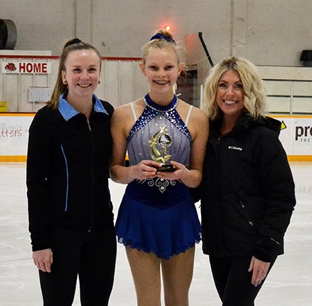 Kati Van Winkoop is presented the Carlyle Skating Club Outstanding Skater Award for 2020 by Kyla Fischer (left) and Jenna Toms (right).