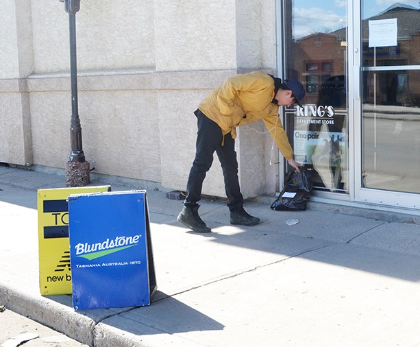 A customer picks up his purchase at King’s Department Store on Main Street in Carlyle.