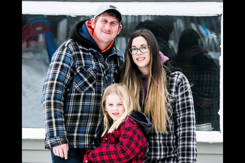 Chris Danis and Taylor Raddysh (right) pose with daughter Aubree (middle) as part of a Front Steps Project photography session. Photographer Sian King has begun taking family portraits of people isolating in their homes. - SUBMITTED PHOTO