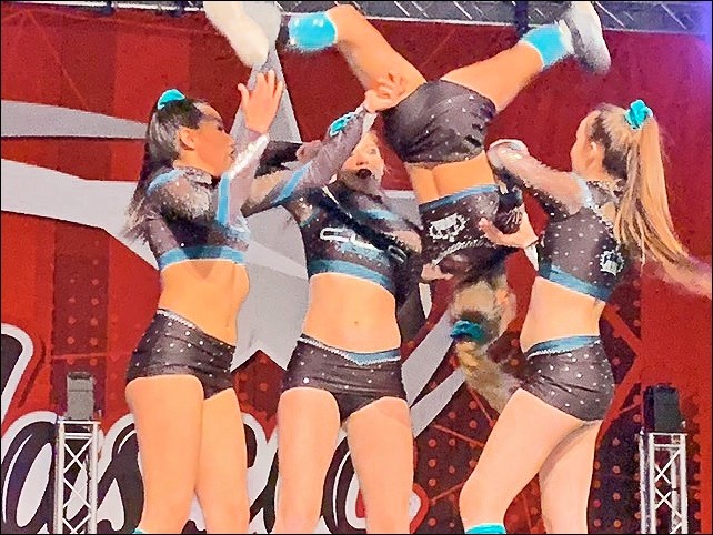 Cheer Legacy Reign, Level 4, uses complex grips as seen in this back layout transition. Body positi