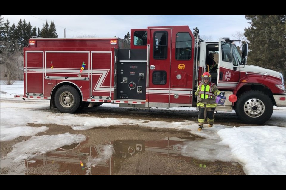 Making a happy birthday delivery to Togo, Lieut. Kristin Johnson dressed in full firefighters gear.