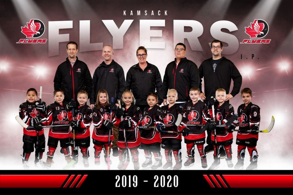 Kamsack IP Flyers Team 1, from left, were: (back) Ryan Gareau and Kevin Kitchen (coaches), Andrea Marsh (manager), John Keewatin and Jeff Smandych (coaches), and (front) Lane Keewatin, Mateo Kazakoff, Xander Gareau, Kascia Bowes, Madelyn Lorenzo, Adrielle Kakakaway, Preston Shabatoski, Emmett Marsh, Emmett Kitchen and Paysen Erhardt.