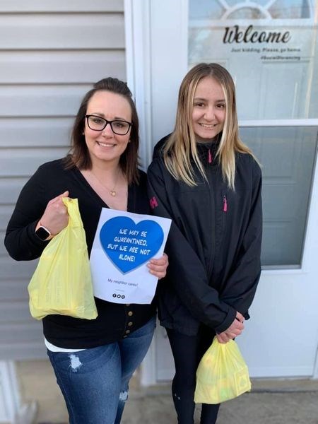 Stacey Strykowski, left, and her daughter Emerson spread some good cheer to their neighbours through a band challenge known as COVID Caring.