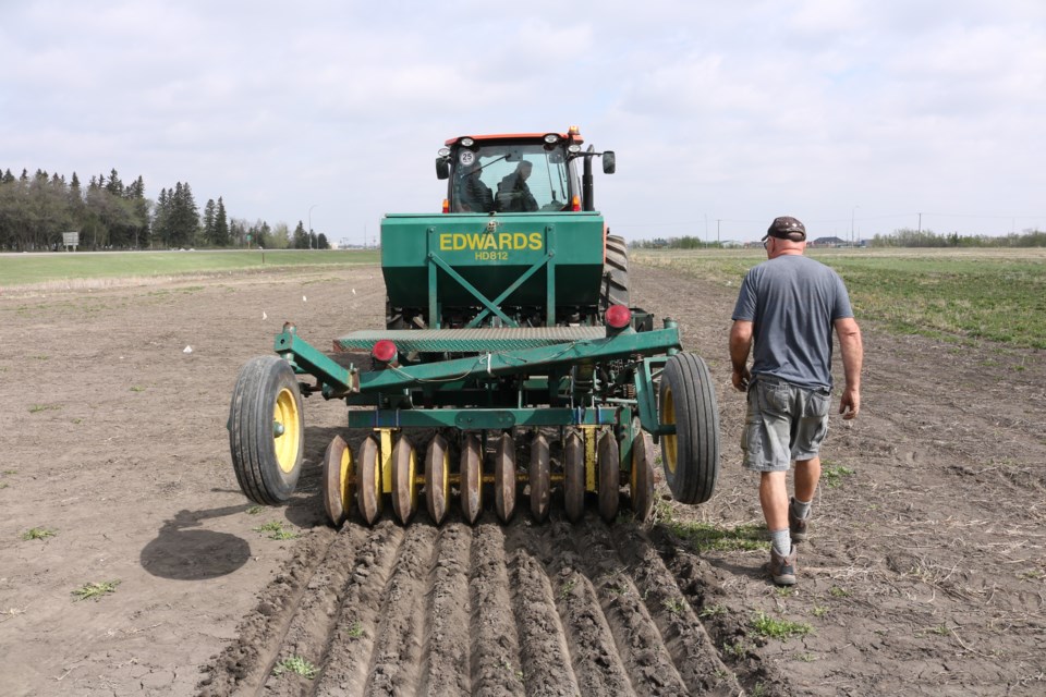 Agrologist Thom Weir follows a test run of the plot seeder.