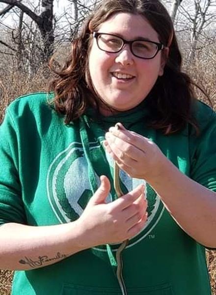 Amanda Leis held one of the thousands of red-sided garter snakes which have recently emerged from hibernation at the Fort Livingstone historic site near Pelly.