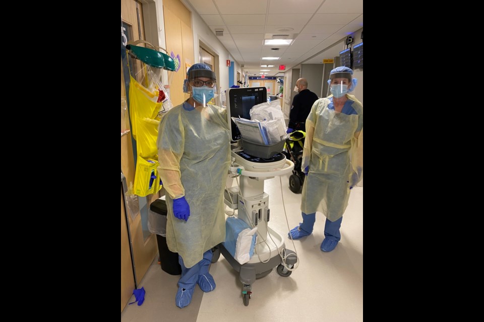 Katie Bell, left, with fellow ICU workers at the hospital in Boston. Photo submitted