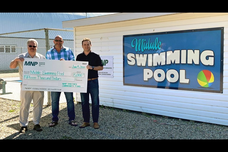 From left, partners with MNP David Hammermeister, left, and Ryan Stepp, right, presented a cheque for the Midale swimming pool to Mayor Allan Hauglum. Photo submitted