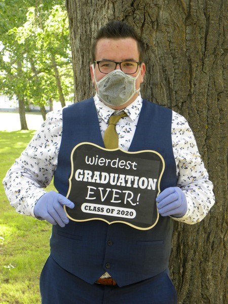 UCHS graduate, Landon Solomko, pokes a little fun at the pandemic in his grad photos. Photo by Sherri Solomko
