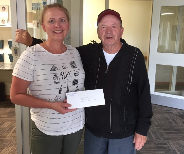 Shylo Peters-Rogers, manager at Jubilee Residence in Flin Flon, holds a cheque alongside resident George Rideout. The group received a grant from the Northern Neighbours Foundation to repair their second floor entrance. - SUBMITTED PHOTO