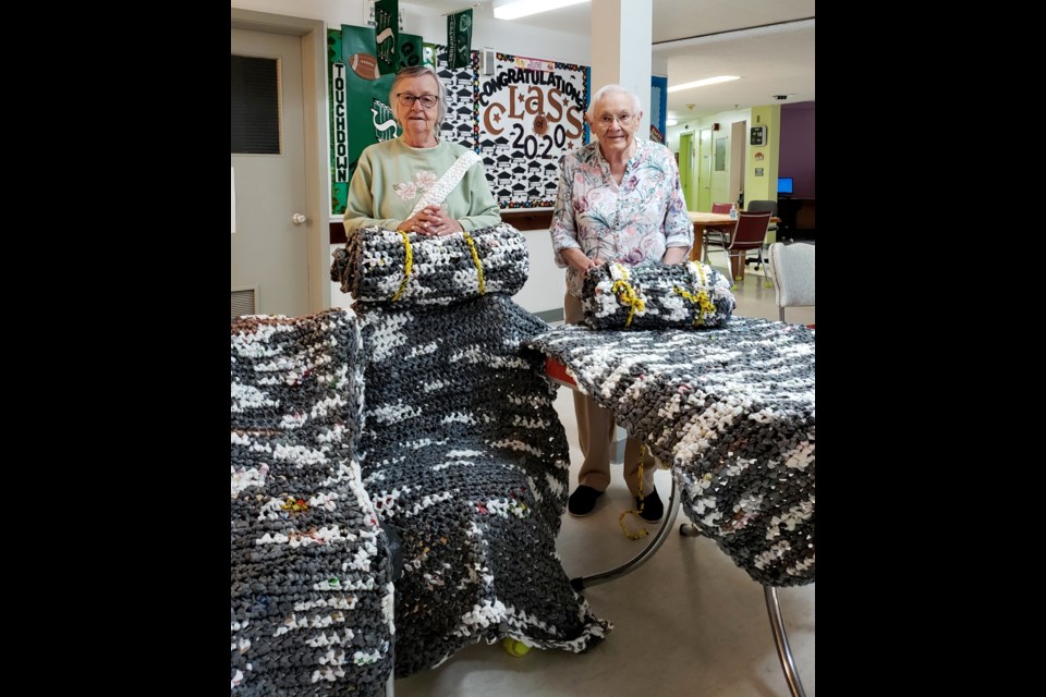 Ida Scott, left, and Frieda Sombrutzki completed two mats each to help homeless people. Photo submitted