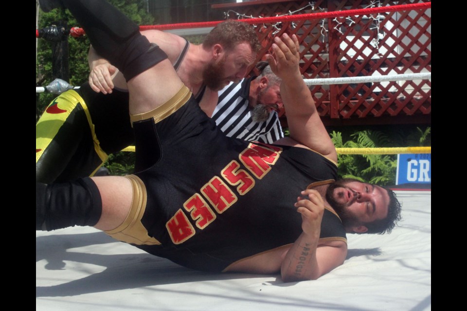 The “Canadian Crusher” AJ Sanchez kicks out of a pinning attempt from Sammy Peppers during a wrestling show in Flin Flon July 4. - PHOTO BY CASSIDY DANKOCHIK