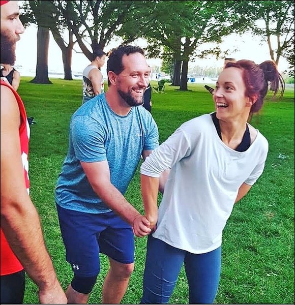 Partner stunting in the Toronto Waterfront Park with cheer friends. Caitlyn Nelson, and husband Chri