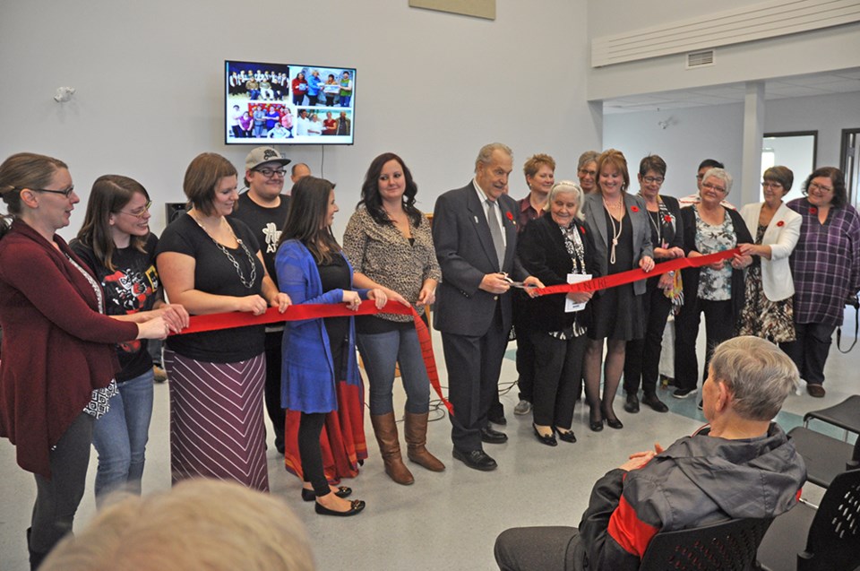 Pius Pfeifer cuts the ribbon at the Pfeifer Learning Centre. Photo by John Cairns