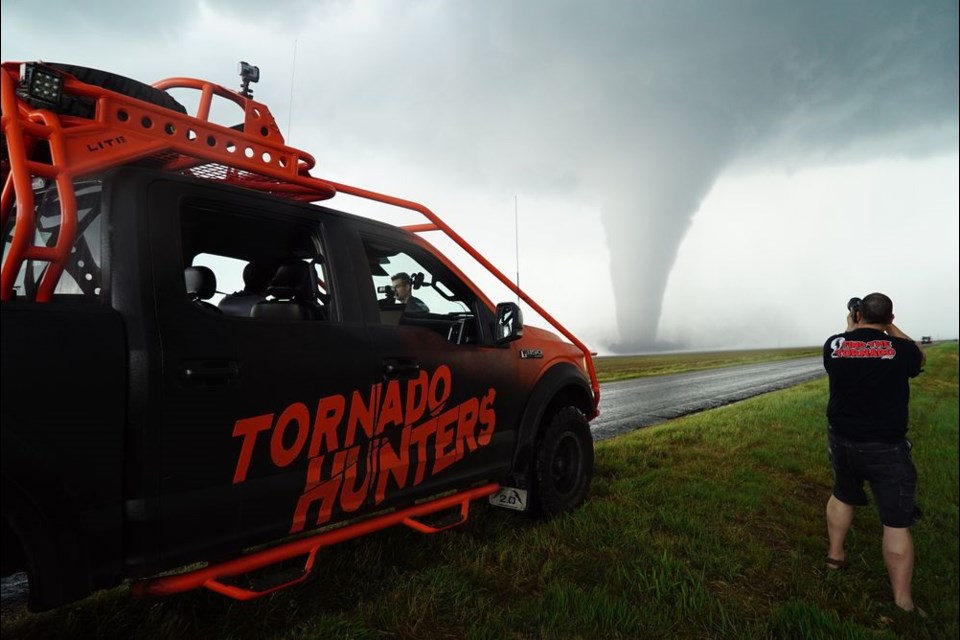 In addition to photographing comets, Notanee Bourassa also takes pictures of severe weather. Here he was seen at work during the 2016 Dodge City, Kansas tornado. -Photo courtesy Greg Johnson
