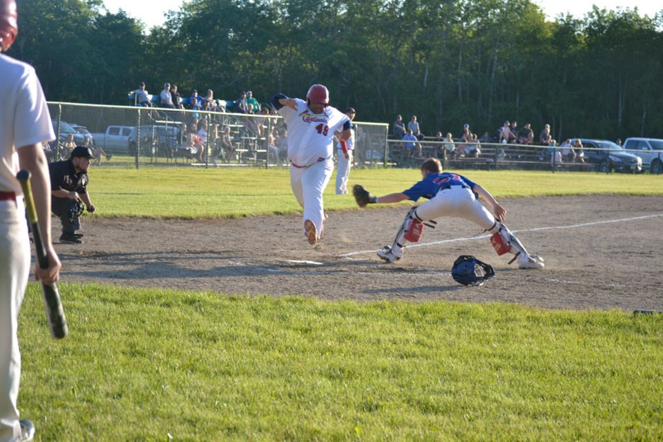 The Cardinals Mason Crossman outstretches the Kenosee Cubs catcher. Photo by Kelly Johnson