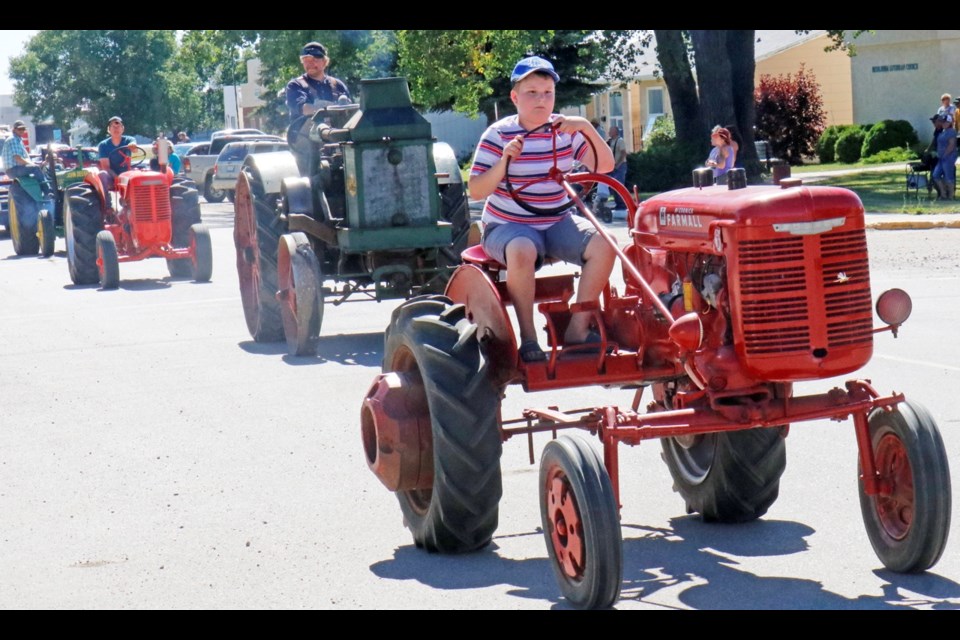 A variety of old tractors were part of the parade through Midale organized by the Souris Valley Antique Association. Photo by Greg Nikkel of the Weyburn Review