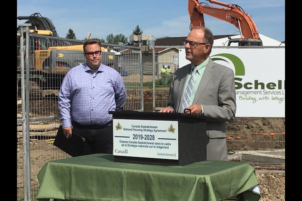 Battlefords MLA Herb Cox speaks at the sod turning for the new eight unit CMHA rental housing project. Councillor Kent Lindgren is looking on.