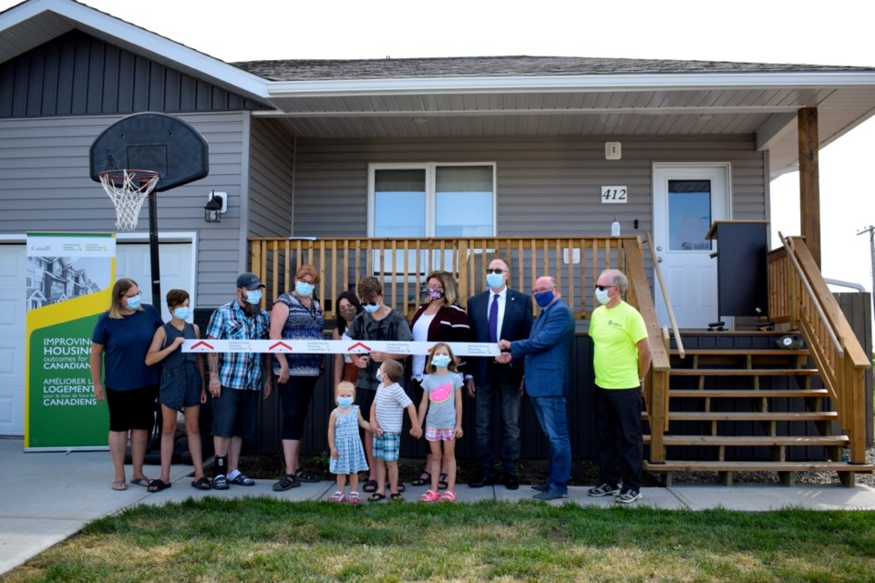 The ribbon was cut to celebrate the Boreski/Lewis family’s possession of the new house, built as a part of Habitat Homeownership Program.