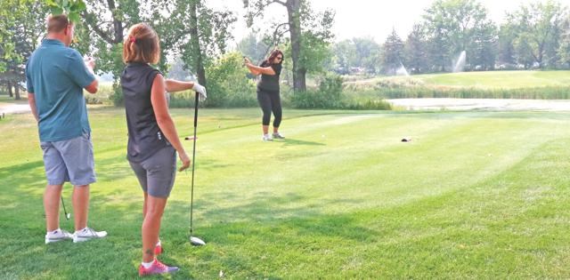 Golfers teeing off